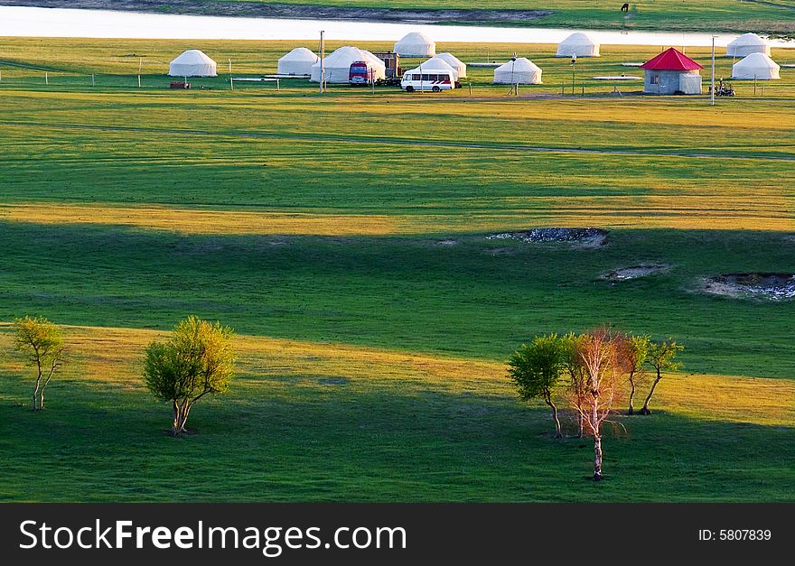 Meadow at dawn with  Mongolia houses and river,china