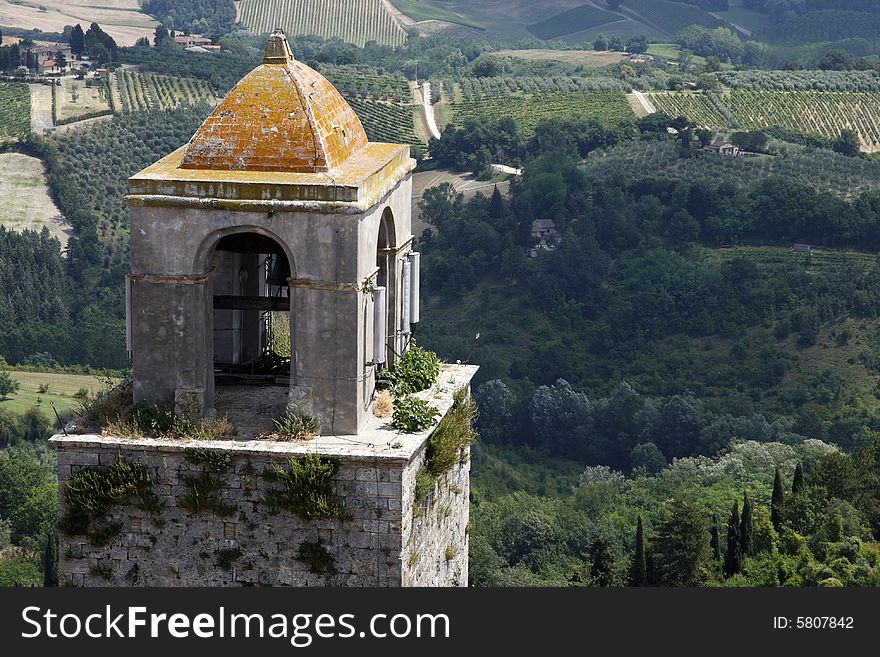 Top of the bell tower with the rolling tuscany countryside beyond from the torre grossa san gimignano tuscany italy europe