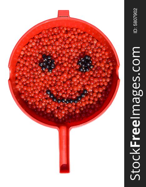 Red and black currants, painting a smile in a red scoop. Red and black currants, painting a smile in a red scoop