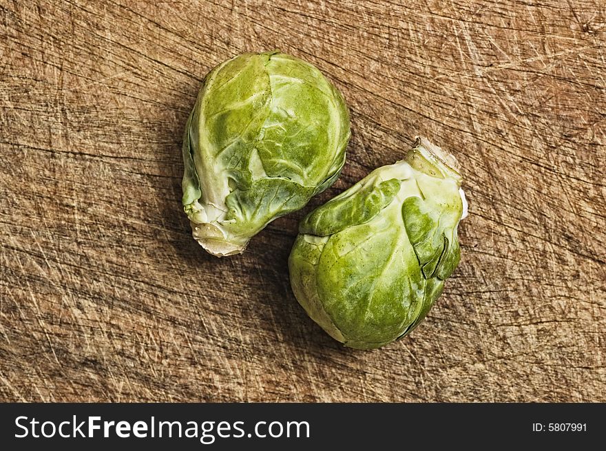 Brussels sprouts, close up, on wooden table,  studio shot.