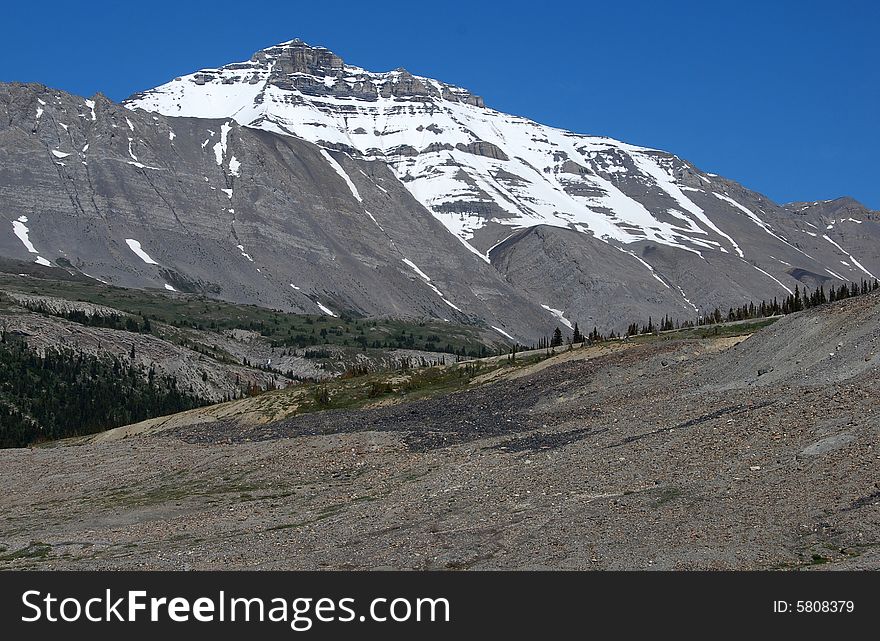 Rocks And Snow Mountain