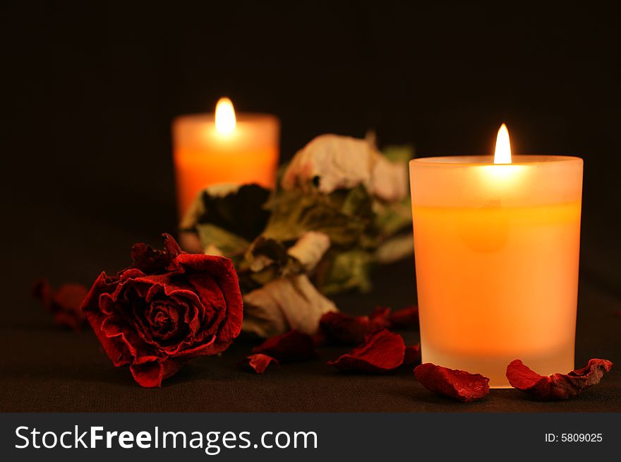 Orange candles with red rose