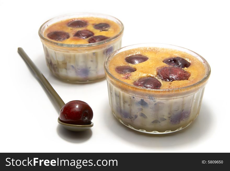Two individual clafoutis with cherries in ramequin