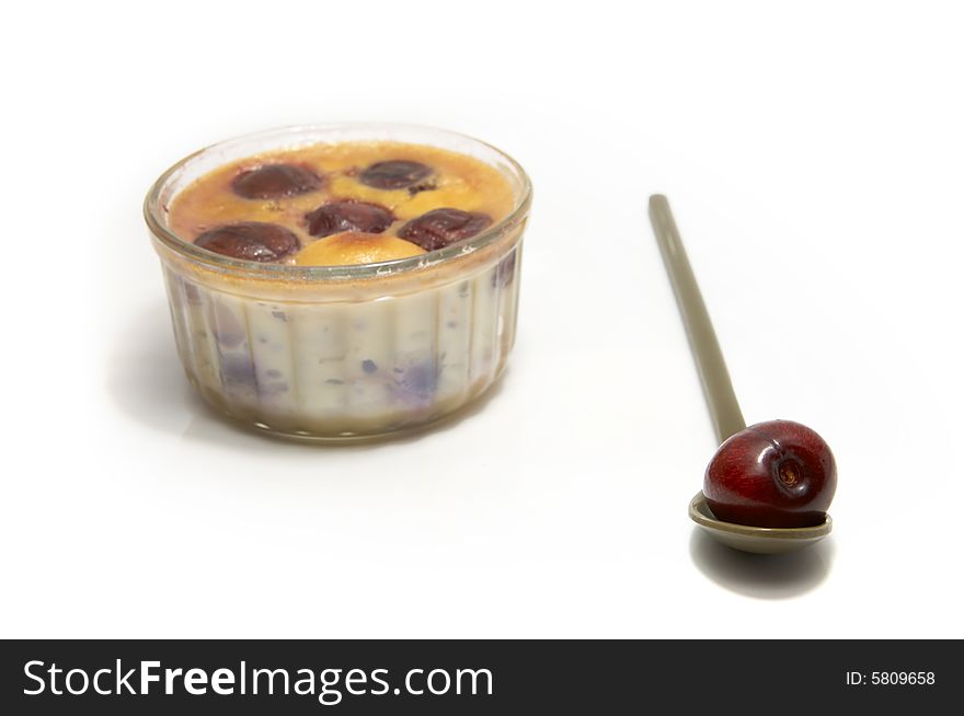 An individual clafoutis with cherries in a ramequin