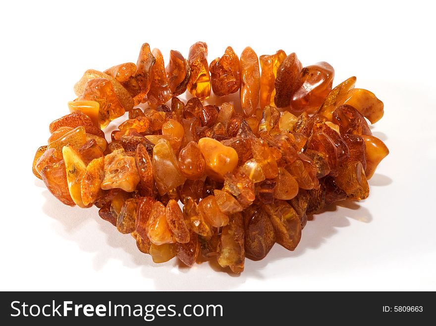 Thread of amber bead on white background. close-up. Thread of amber bead on white background. close-up.