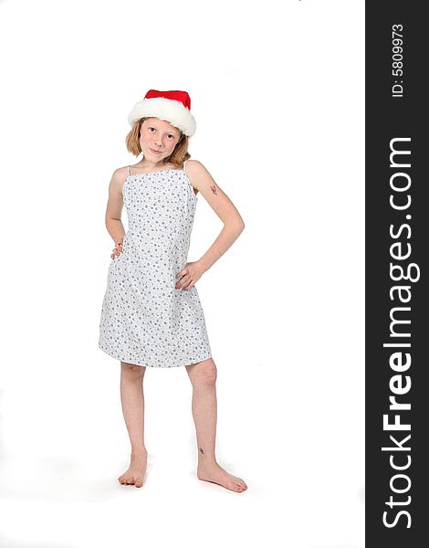Cute young girl in dress and a santa hat. Cute young girl in dress and a santa hat