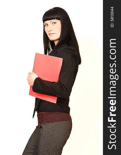 A young pretty businesswoman standing in a studio with a red 
folder in her hand. A young pretty businesswoman standing in a studio with a red 
folder in her hand.