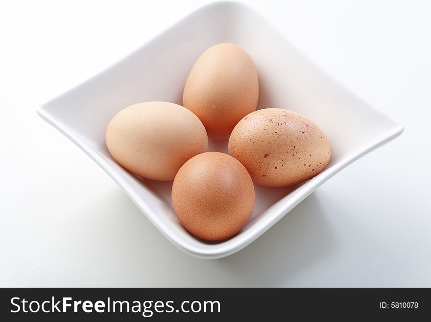 Four eggs in a white bowl
