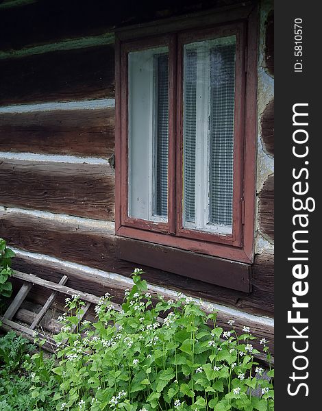 Old wooden village house, window detail. Old wooden village house, window detail