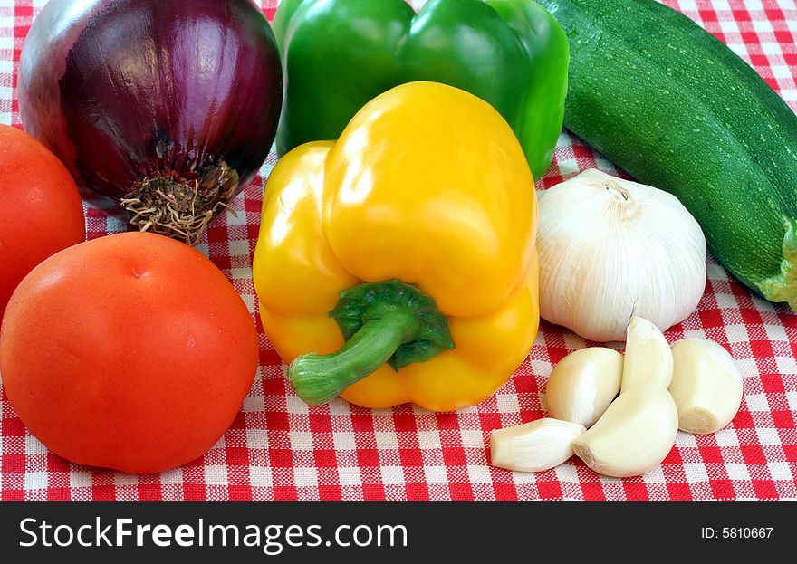 Mixed colorful garden fresh vegetables including tomatoes, peppers, red onion and more. Mixed colorful garden fresh vegetables including tomatoes, peppers, red onion and more.