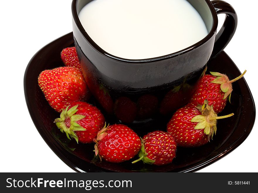 Black cup of milk and strawberries, isolated on white