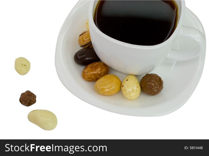 Candies and white coffee cup, isolated on white