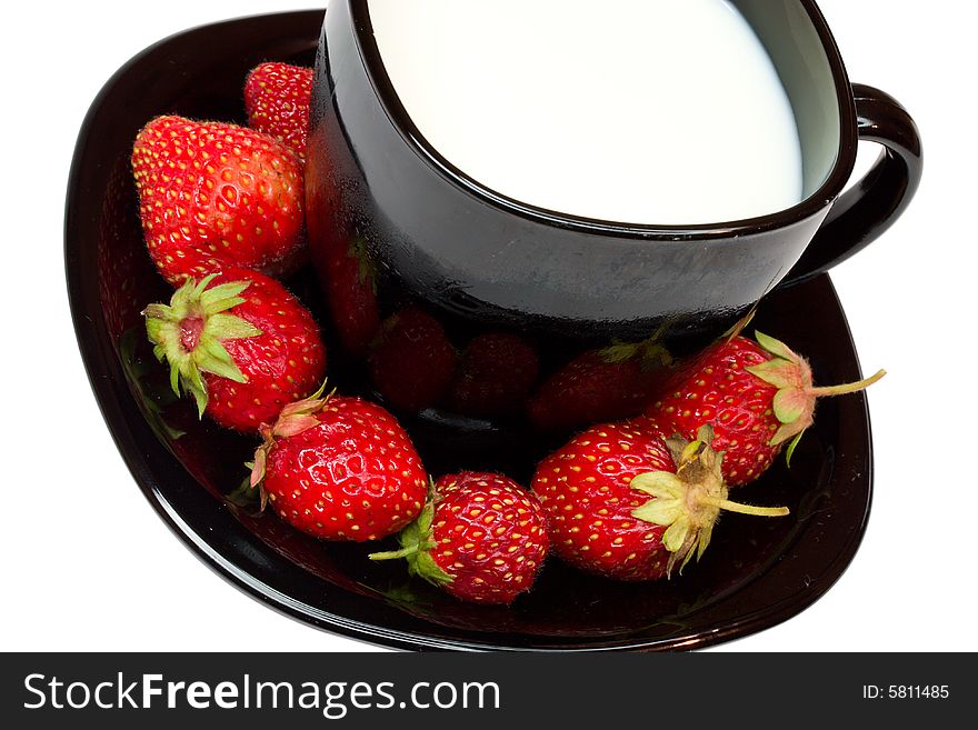 Strawberries and black cup of milk, isolated on white