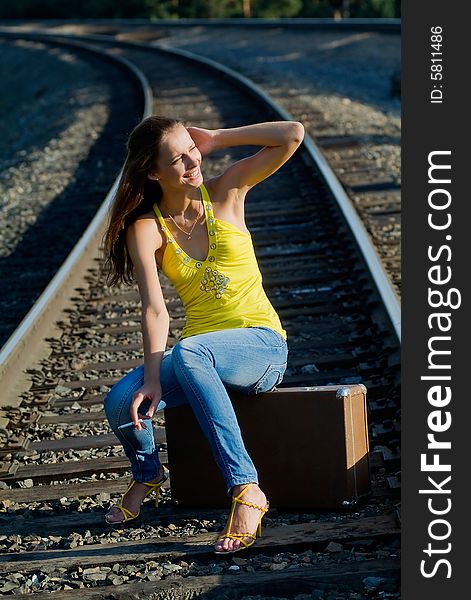 The young woman walks by rail