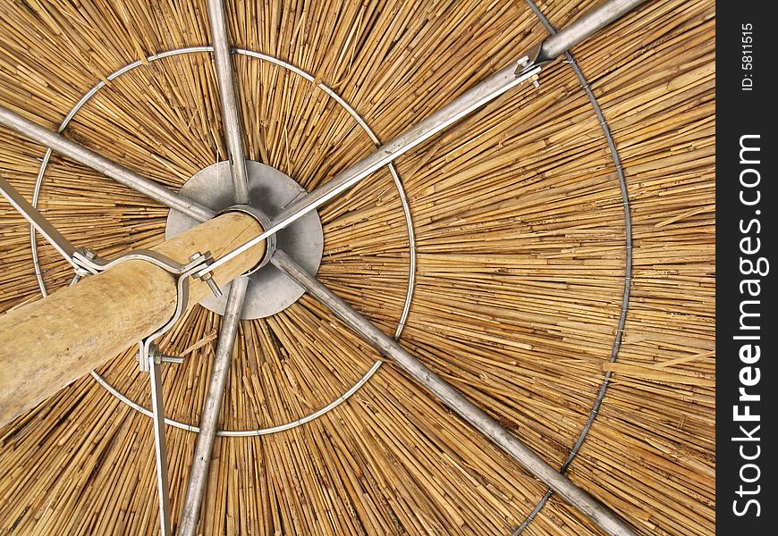 Detail of round straw umbrella for summer shade