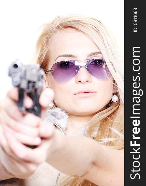 Portrait of a lovely lady with a gun aiming at you on white background. Portrait of a lovely lady with a gun aiming at you on white background
