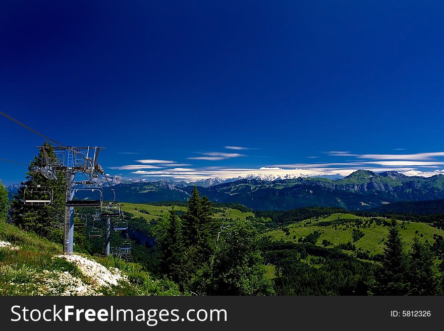 Chair lift with mountains during summer. Chair lift with mountains during summer
