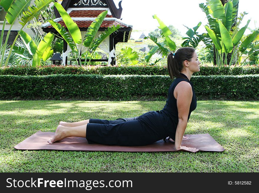 Young woman practicing yoga in the park.