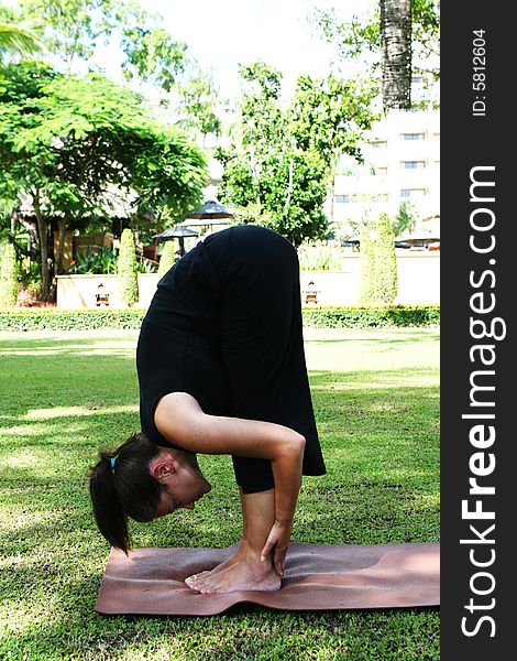 Young woman practicing yoga in the park.