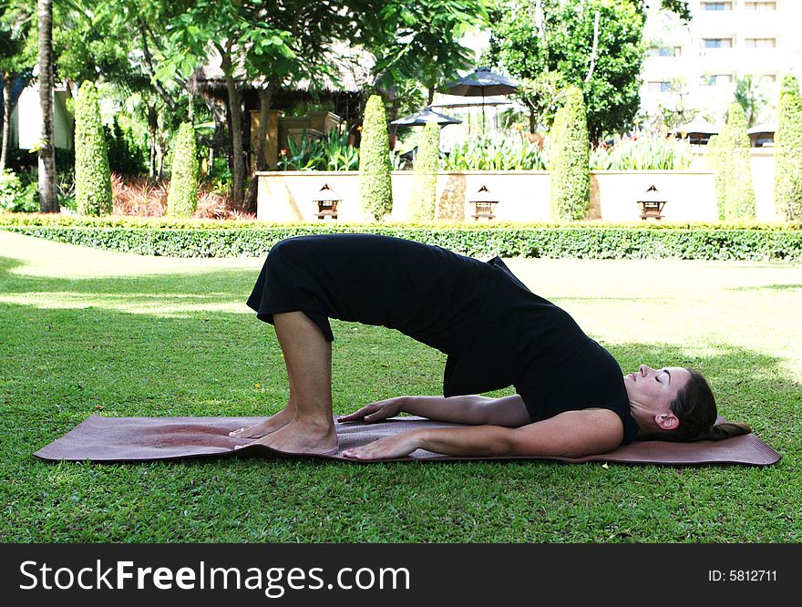 Young woman practicing yoga in the park.