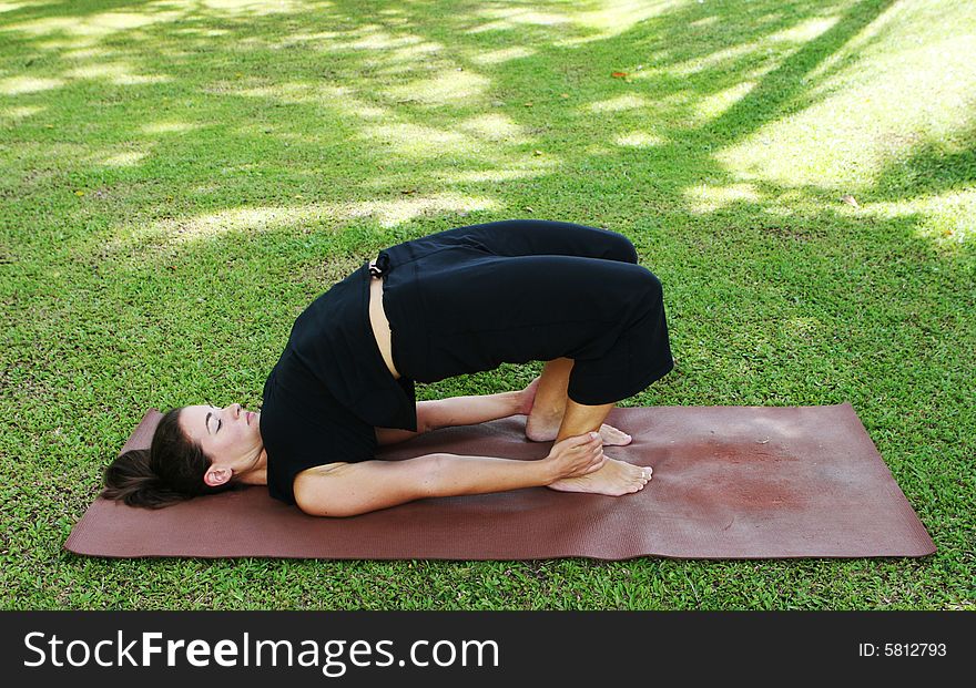 Young woman practicing yoga in the park.