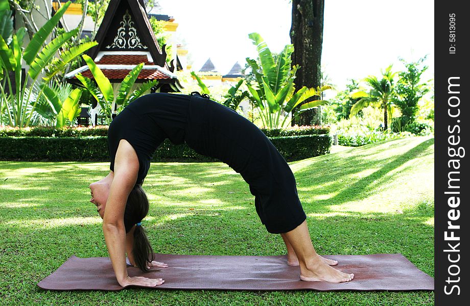 Young woman practicing yoga in the park.