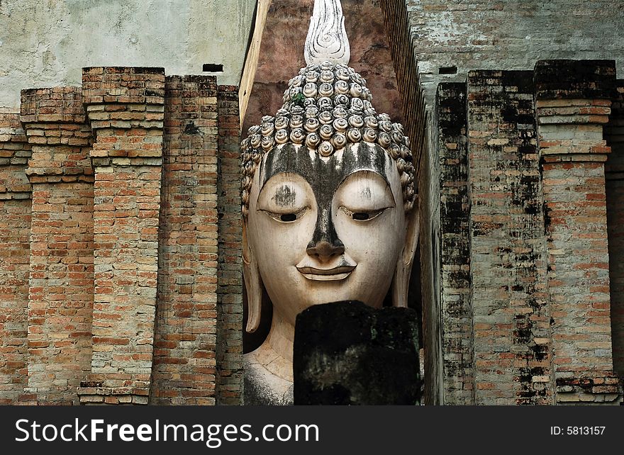 Thailand, Sukhothai or Sukothai was the capital of the Thai Empire founded in 1238. Detail of a seated Buddha at Wat Si Chum, Phra Atchana or Ajana. Thailand, Sukhothai or Sukothai was the capital of the Thai Empire founded in 1238. Detail of a seated Buddha at Wat Si Chum, Phra Atchana or Ajana.