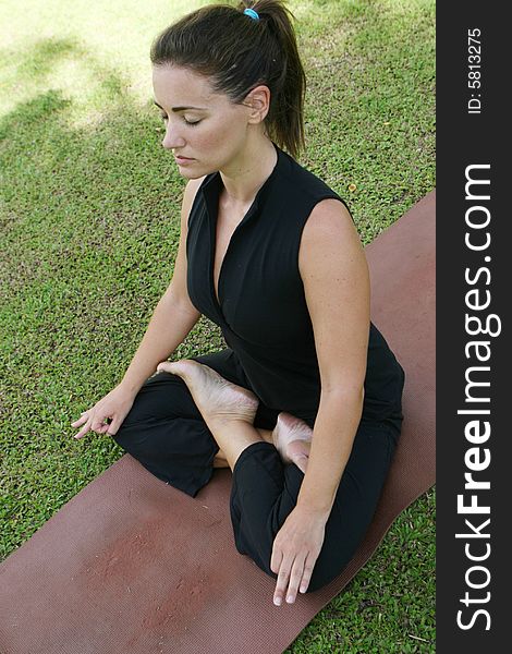 Young woman practicing yoga in the park.