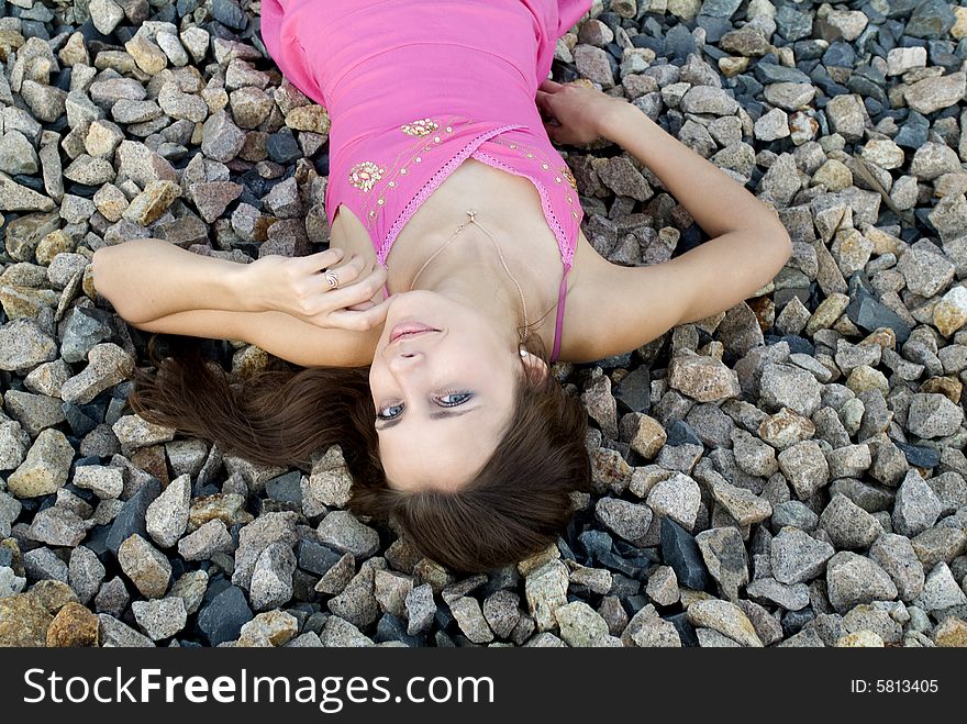 The young woman dreams laying on stones. The young woman dreams laying on stones
