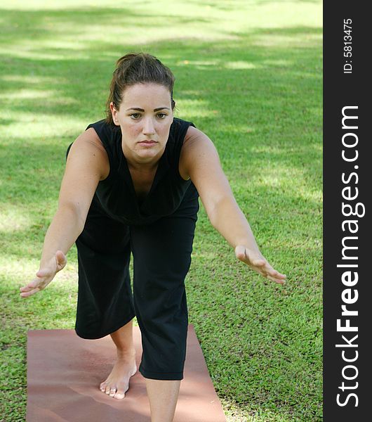 Young woman practicing yoga in the park.