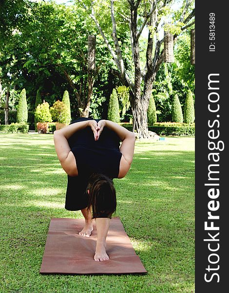 Young woman practicing yoga in the park.