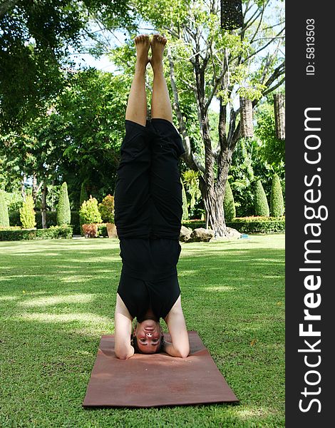 Young woman practicing yoga in the park.