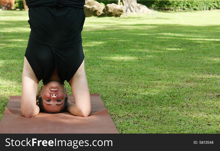 Young woman practicing yoga in the park.