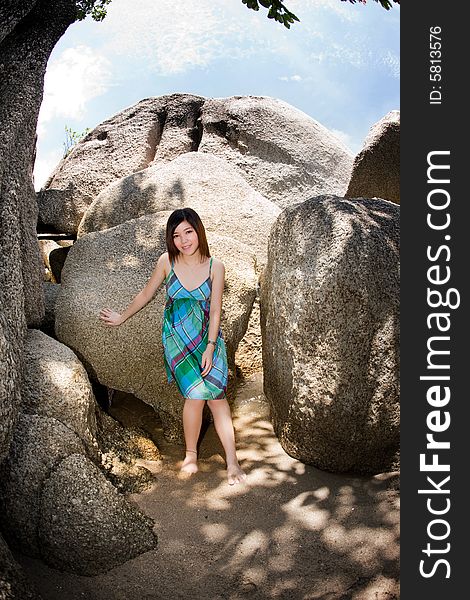 Young asian woman outdoor surrounded by big rocks. Young asian woman outdoor surrounded by big rocks
