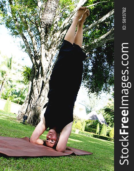 Young woman practicing yoga in the park.