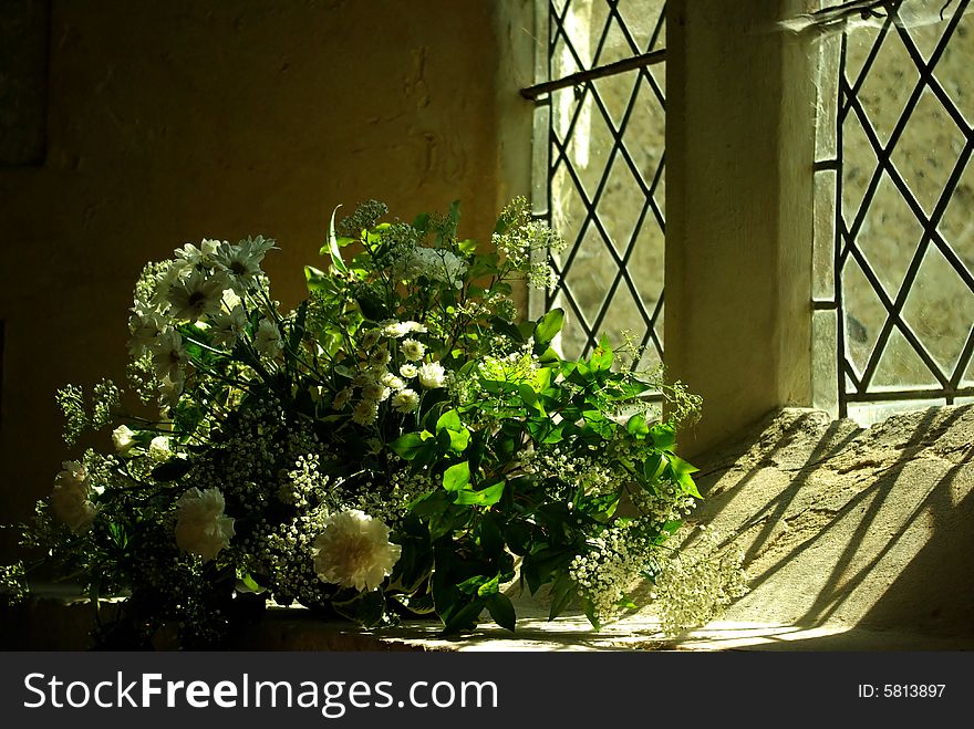 Bouquet of white roses in a church for a wedding. Bouquet of white roses in a church for a wedding.