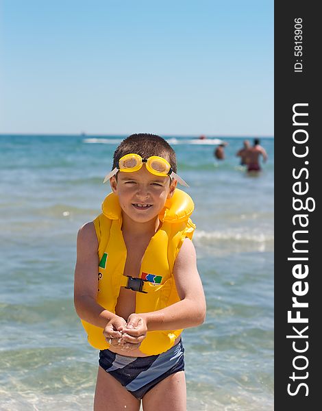 Boy with yellow safety equipment at the seaside. Boy with yellow safety equipment at the seaside