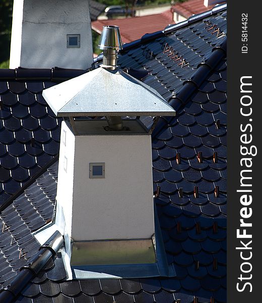 A particular chimney on a slate's roof