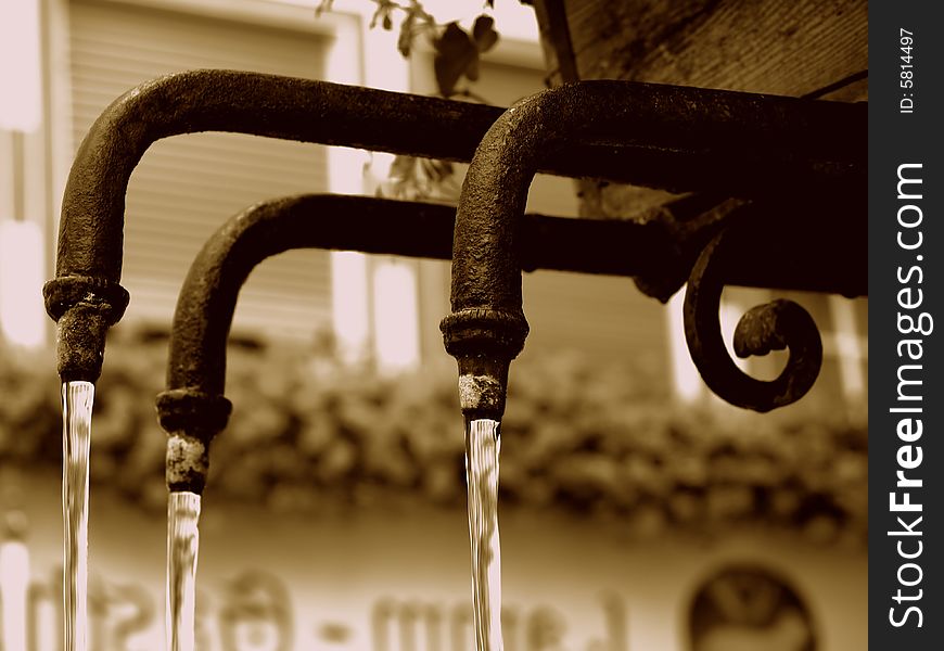 A suggestive shot of three pipes of an ancient fountain. A suggestive shot of three pipes of an ancient fountain