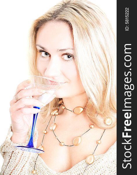 Portrait of a lovely blonde in pullover holding a glass on white background. Portrait of a lovely blonde in pullover holding a glass on white background