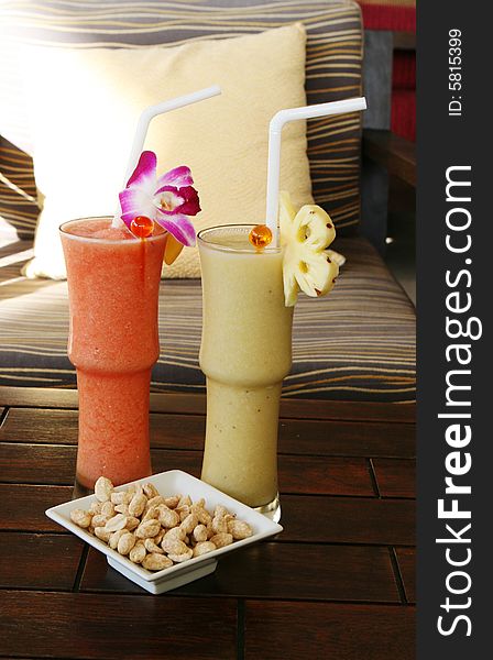 Tropical fruit shakes and a bowl of nuts. Tropical fruit shakes and a bowl of nuts.