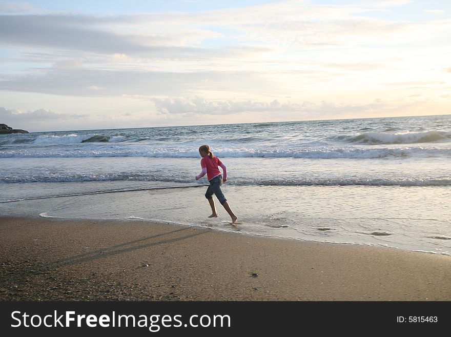 Running girl on the sunset beach. Running girl on the sunset beach