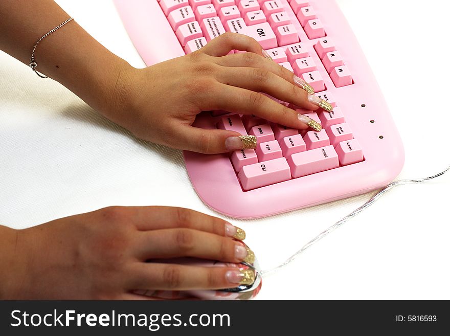 Hands of the girl on keyboard and mouse