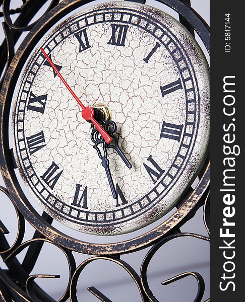 Old vintage metal clock with red arrow