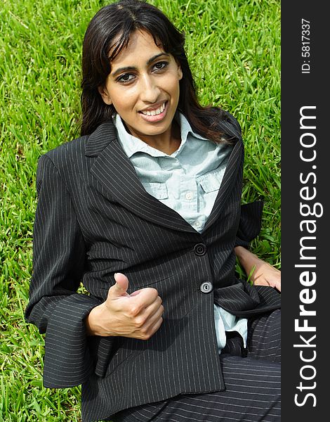 Woman smiling and showing a thumbs up gesture. Woman smiling and showing a thumbs up gesture