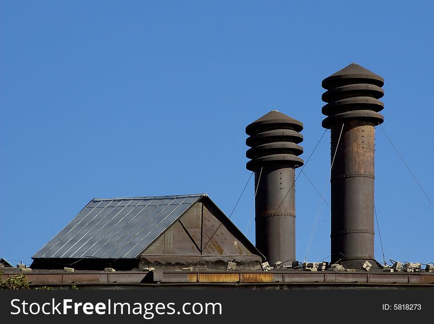 Two chimneys against a clear blue sky. Two chimneys against a clear blue sky.