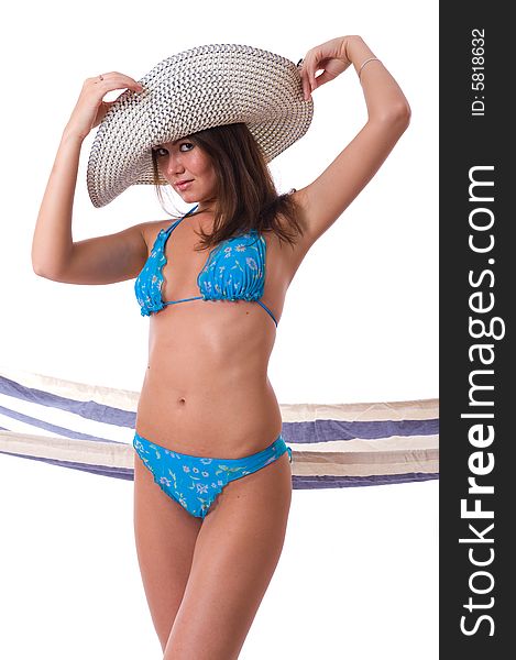 Sexy woman wearing bikini with summer hat and hammock on the background