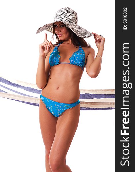 girl wearing bikini with summer hat and hammock on the background. girl wearing bikini with summer hat and hammock on the background