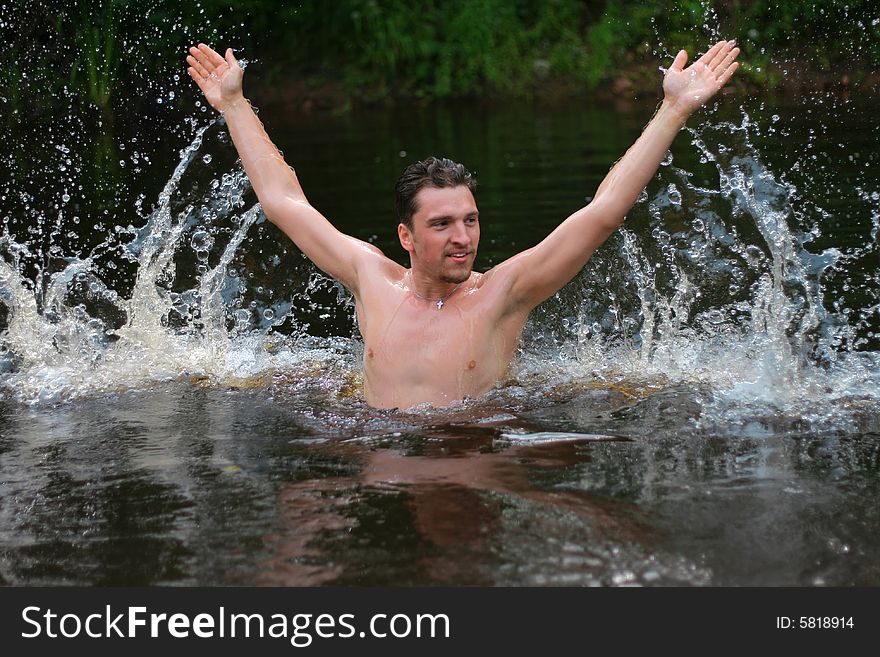 Young man jumps from the water