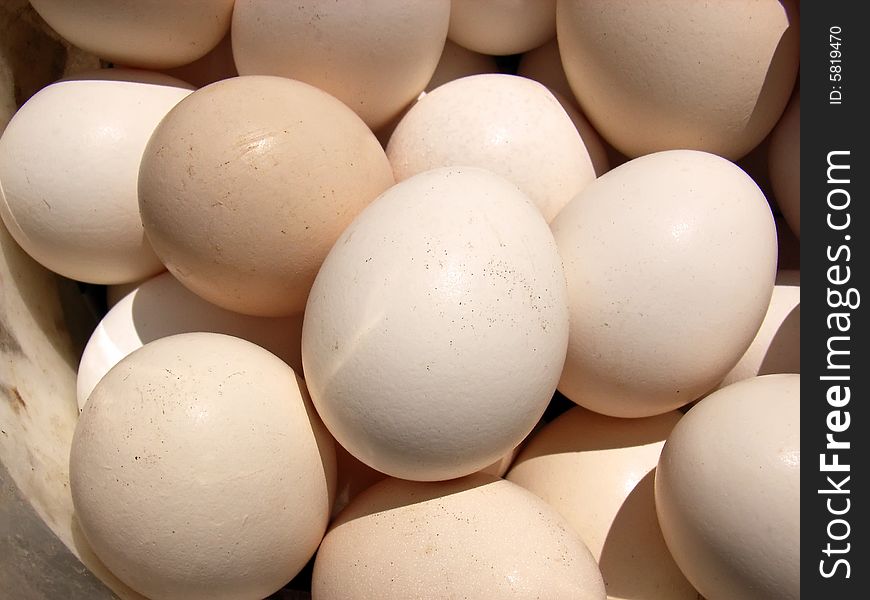 Several natural white hen eggs in a basket. Several natural white hen eggs in a basket